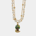 Collana in metallo con testa di moro verde e perle bianche | Rohome